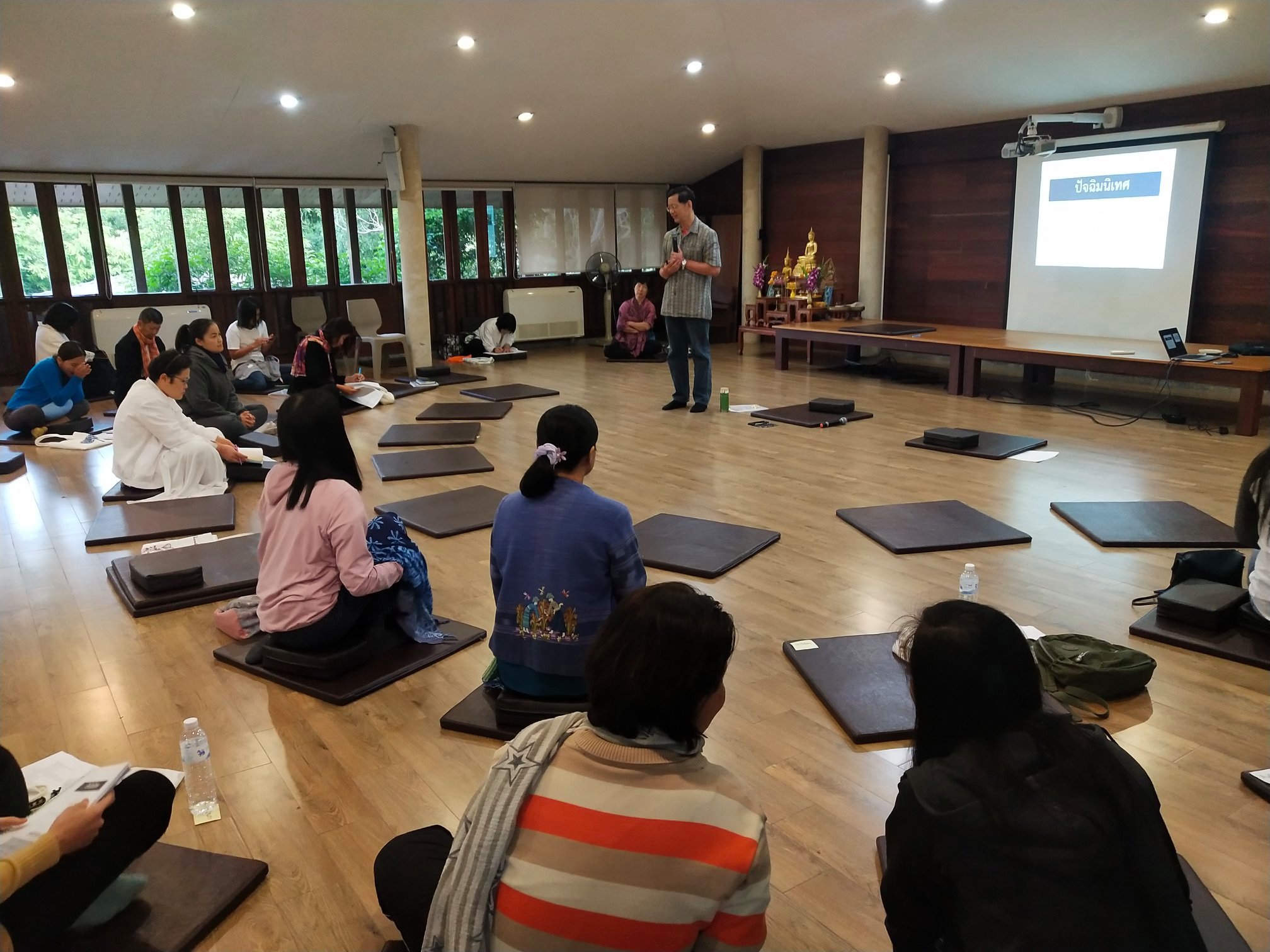 Participants attending a mindfulness training session during the Mindfulness in Organization (MIO) program in Thailand.